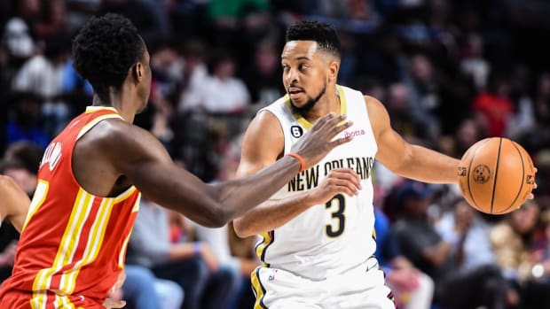 Oct 14, 2022; Birmingham, Alabama, USA; New Orleans Pelicans guard CJ McCollum (3) drives on Atlanta Hawks forward Onyeka Okongwu in the second quarter at Legacy Arena at BJCC. Mandatory Credit: Larry Robinson-USA TODAY Sports